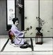 Japan: A geisha arranging flowers, c.1895
